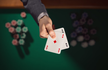 Poker player holding two aces