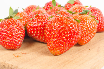 Group of strawberries on wooden board  isolated on white backgro