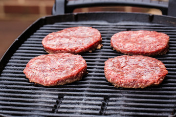 Preparing a batch of  grilled ground beef patties or frikadeller