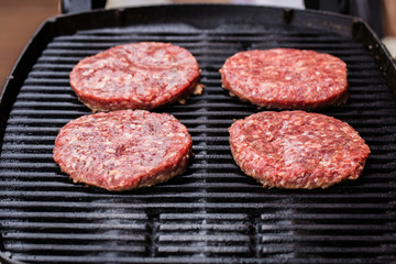 Preparing a batch of  grilled ground beef patties or frikadeller