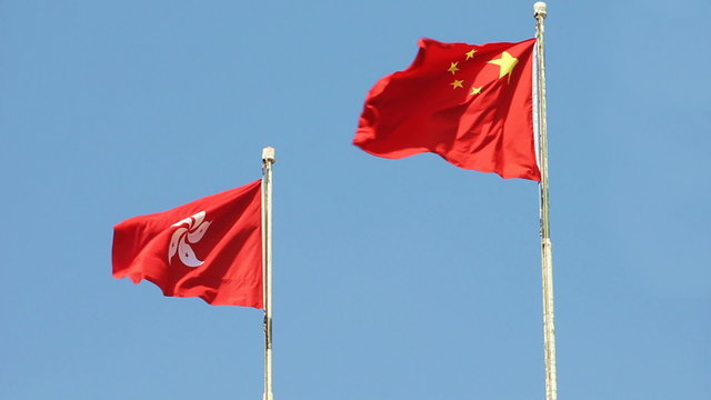 Flags of China and Hong Kong SAR waving in the wind