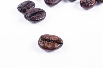 Close up of roasted coffee beans isolated on white background