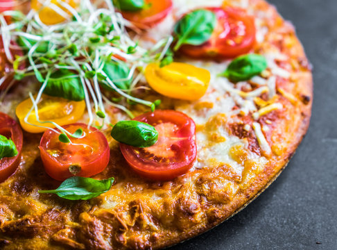 Pizza with tomatoes and basil
