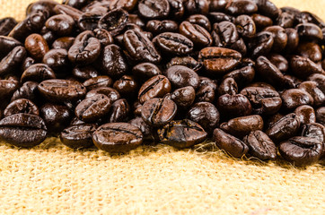roasted coffee beans on sack cloth background