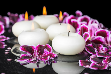 beautiful spa concept of geranium flower, beads and candles in r