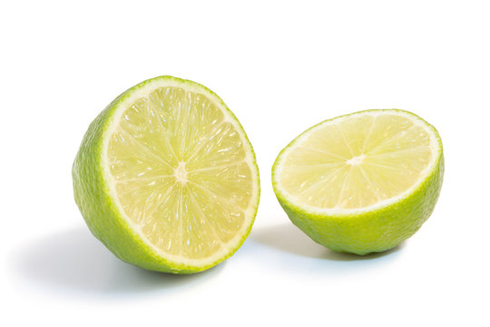 Closeup of a ripe lime fruit cut in half isolated on white