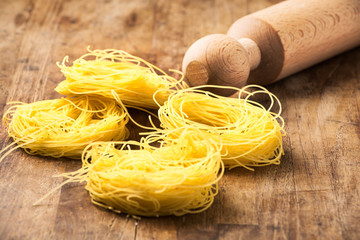 italian traditional pasta and rolling pin on wood desk