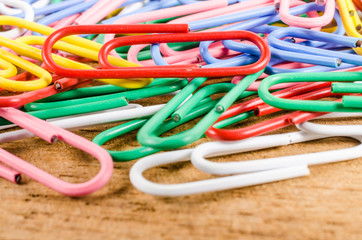 group of colorful paper clip on wooden board