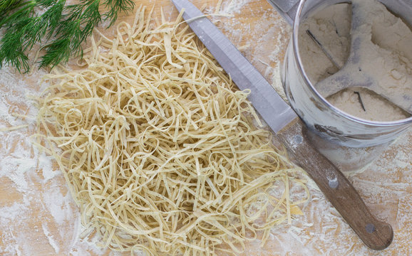 Fresh homemade noodles with dill on the table