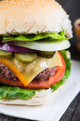 closeup pub style burger on wooden table