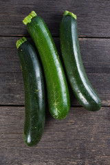 fresh courgettes on wooden table