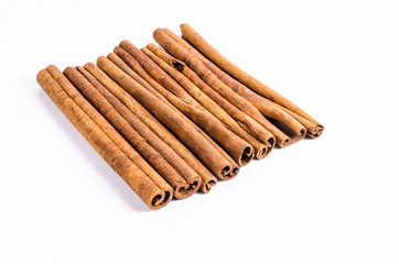 Row of stick cinnamon isolated on white background
