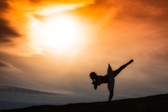 Ballerina silhouette, dancing alone in nature in the mountains a