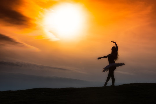 Ballerina silhouette, dancing alone in nature in the mountains a