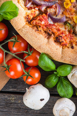 Fresh homemade vegetarian pizza with ingredients, overhead