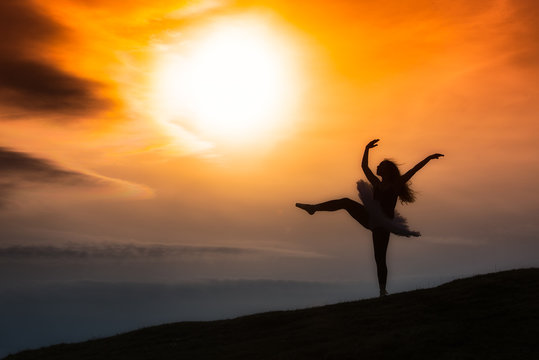 Ballerina silhouette, dancing alone in nature in the mountains a