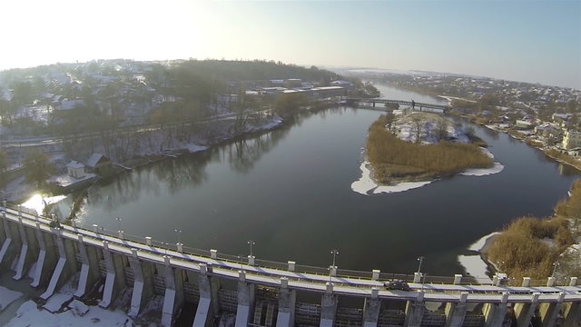 Dam on the beautiful river. Aerial with turn