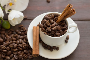 Coffee beans with cinnamon and orchid flowers