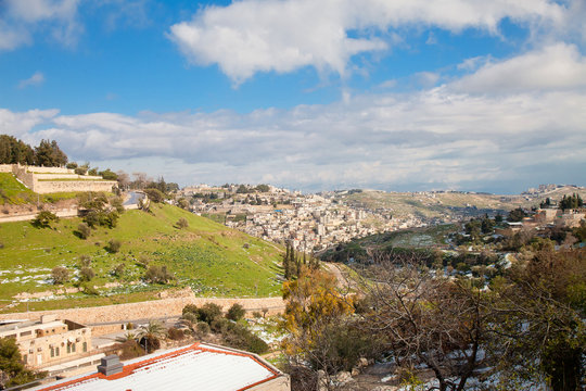 Kidron Valley in Jerusalem with snow and blue sky