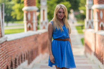 Girl in blue dress enjoying summer day