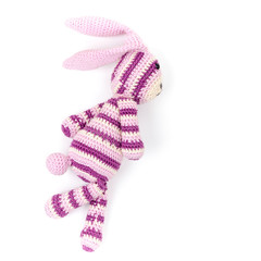 Knitted rabbit toy is running fast, closeup photo