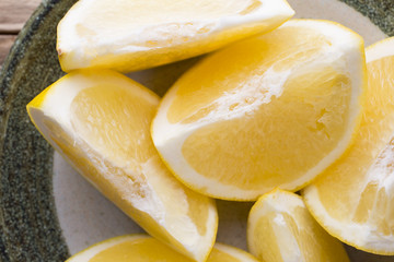 Yellow grapefruit slice on a plate.
