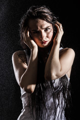 Wet sexy woman covered with water drops