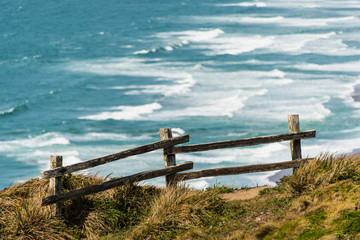 Wooden fence on a cliff by the Pacific Ocean