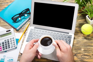 Laptop. Financial business news online on a laptop with coffee