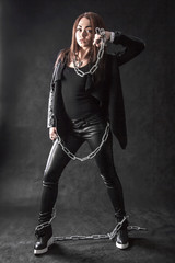 Fototapeta premium Young woman in a black clothes with a chain