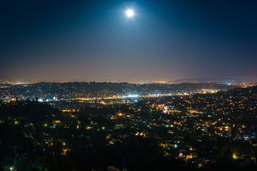 Fototapeta premium The moon over Northeast Los Angeles at night, seen from Griffith