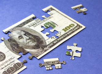 Dollars puzzle. Concept of finance and savings