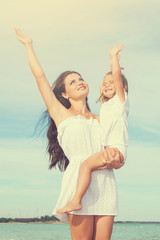 Mother and her daughter  having fun on the beach