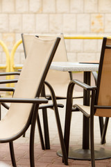 white and black restaurant chairs outdoor. Open cafe.