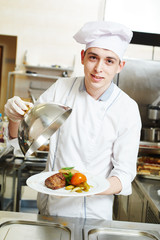 cook chef with food in kitchen