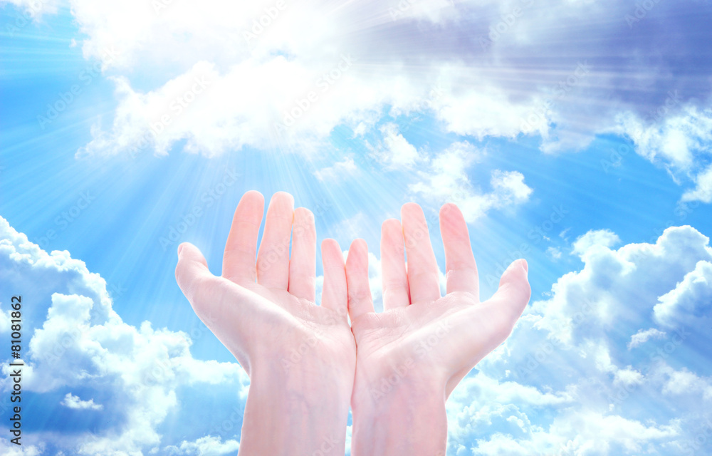 Wall mural Human hands on sky background