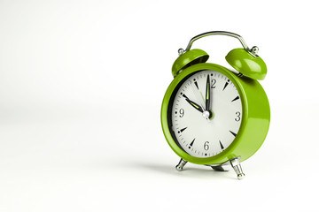 Ten o'clock. Green classic clock on white background.