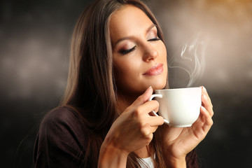 Beautiful young woman with cup of coffee