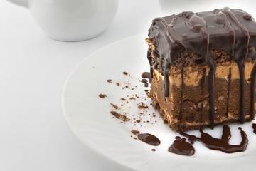 Chocolate cake slice with nut on plate on white background