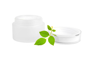 Cream can and green leaf, isolated on white background