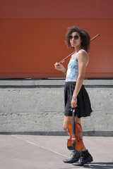 Biracial female violinist with violin, bow, and sunglasses