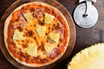 Hawaiian Pizza , pineapple , ham and cheese on wooden background