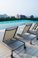 Fototapeta premium Swimming pool on top of roof deck building.
