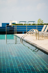 Swimming pool on top of roof deck building.