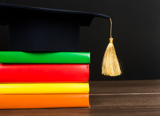 Graduation mortarboard on top of stack of books