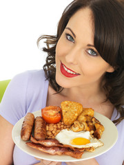 Young Woman Eating a Full English Breakfast