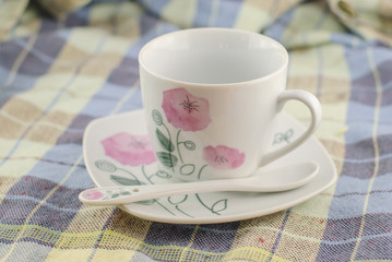 cup of coffee on fabric