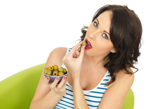 Young Woman Eating Green Olives