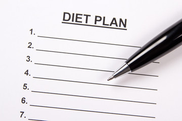 close up of sheet of paper with diet plan and pen