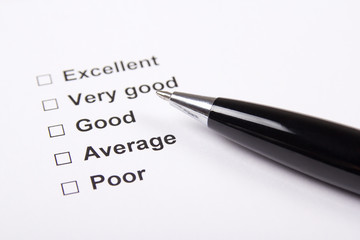 consumer survey with questionnaire checkbox and pen